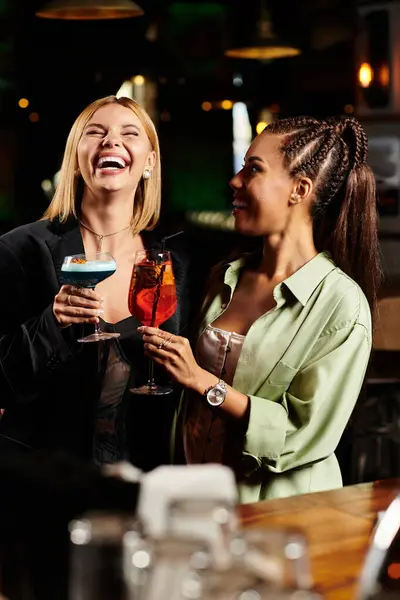 Colleagues share laughter and drinks, enjoying a vibrant corporate celebration with friends. — Stock Photo