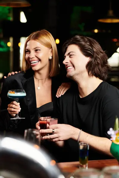 Colleagues enjoy drinks and laughter while celebrating at a festive corporate party. — Stock Photo