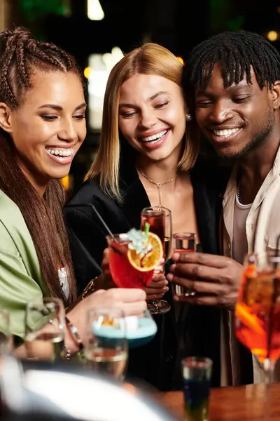 Colleagues share laughter and clink glasses in a lively atmosphere during a nighttime gathering. — Stock Photo