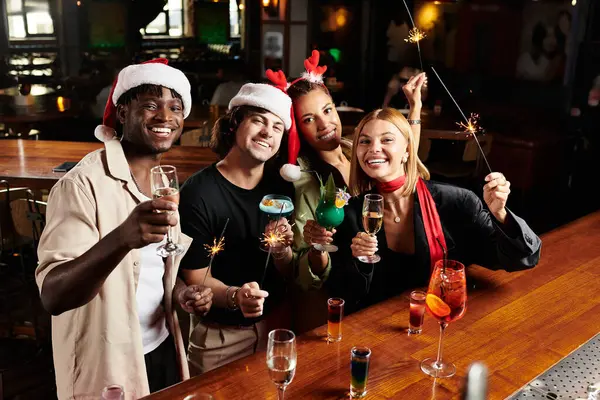 Colleagues gather at a vibrant corporate party, enjoying festive drinks and laughter together. — Stock Photo