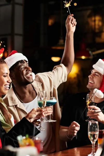 A festive atmosphere surrounds young professionals as they celebrate with drinks and sparklers. — Stock Photo