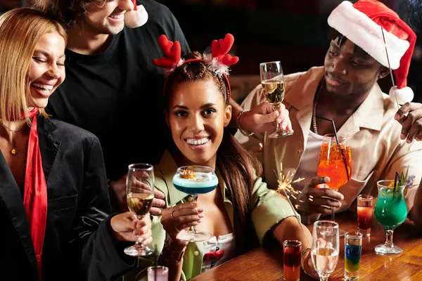 Young professionals enjoy cocktails and laughter at a vibrant holiday gathering with friends. — Stock Photo
