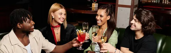 Diverse young professionals enjoy drinks and laughter together at a lively corporate gathering. — Stock Photo