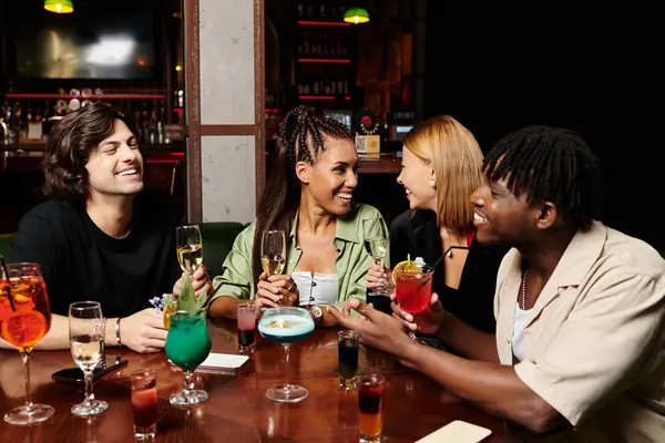 A group of diverse young professionals enjoys drinks and laughter at a vibrant corporate gathering. — Stock Photo