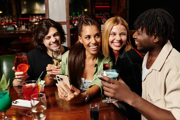 Young professionals enjoy cocktails and camaraderie during a vibrant corporate celebration. — Stock Photo