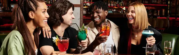 A group of young professionals enjoy drinks and laughter while celebrating at a corporate event. — Stock Photo