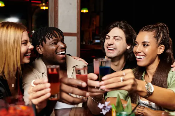 A lively celebration unfolds as young colleagues toast with vibrant drinks at a corporate gathering. — Stock Photo