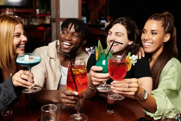 Colleagues share laughter and clink glasses while celebrating their achievements at a vibrant party. — Stock Photo