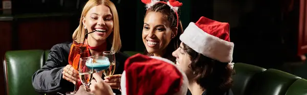 Young professionals enjoy drinks and laughter at a vibrant corporate holiday party. — Stock Photo