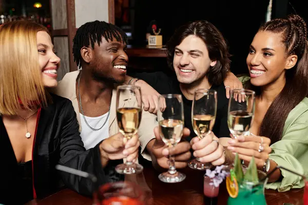 A lively group of young professionals toasting with glasses in a vibrant corporate celebration. — Stock Photo