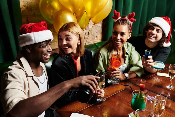 Kollegen feiern fröhlich mit, lachen und trinken gemeinsam. — Stockfoto