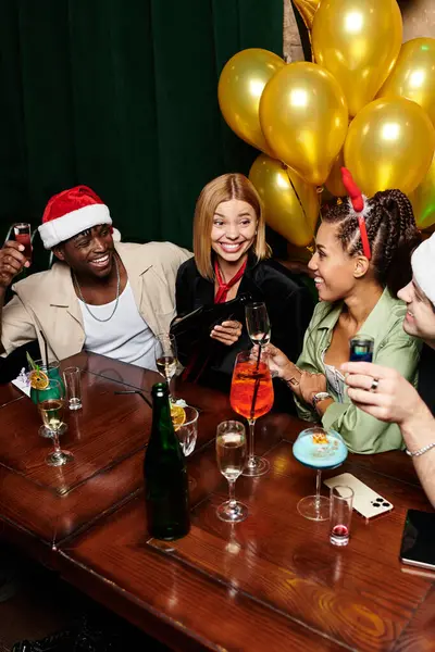 Young, diverse colleagues joyfully celebrate with drinks at a lively corporate event. — Stock Photo