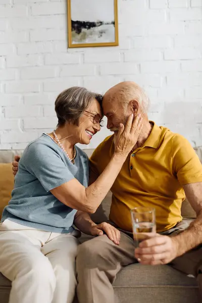 A loving couple shares a tender moment as the wife helps her husband manage his diabetes at home. — Stock Photo