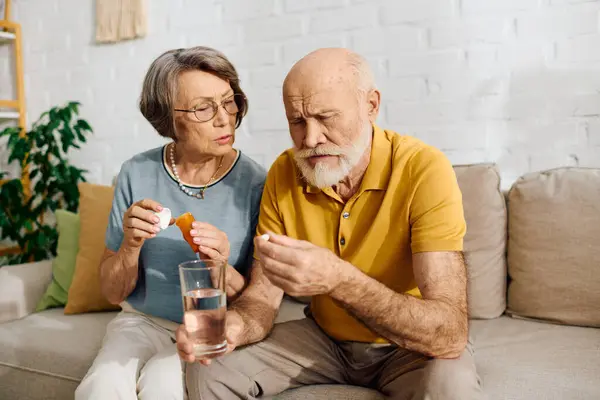 A senior couple shares a moment as the wife helps her husband manage his diabetes treatment. — Stock Photo