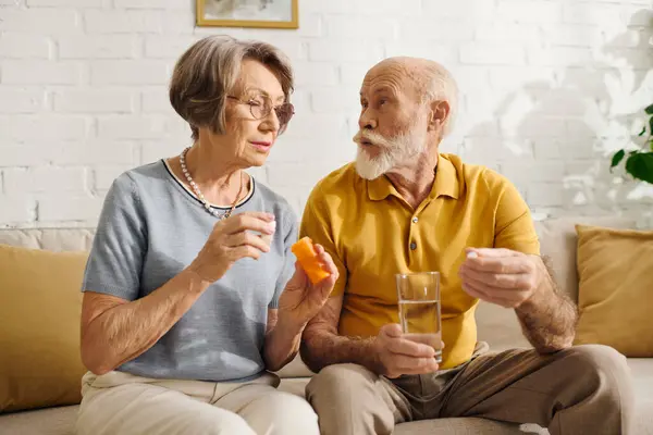 A senior couple shares a moment as the wife assists her husband with diabetes management. — Stock Photo