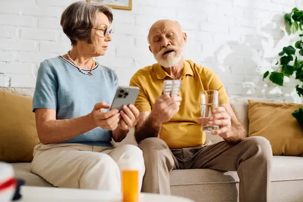 A devoted wife assists her husband with diabetes as they manage his medication together. — Stock Photo