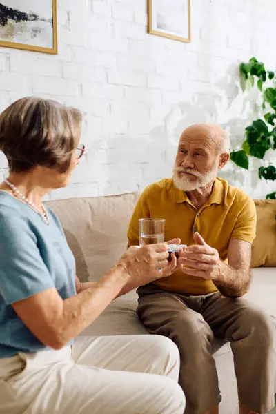 A devoted wife assists her husband with diabetes, showcasing love and support in their home. — Stock Photo