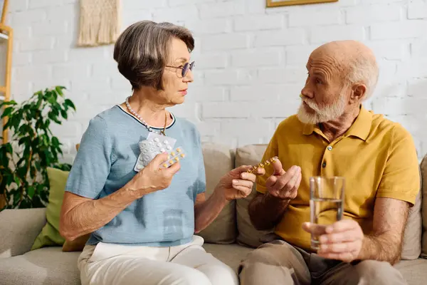 A devoted wife assists her husband, who has diabetes, with his medication while at home. — Stock Photo