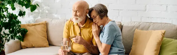 A devoted wife lovingly assists her husband managing diabetes in their cozy living room. — Stock Photo