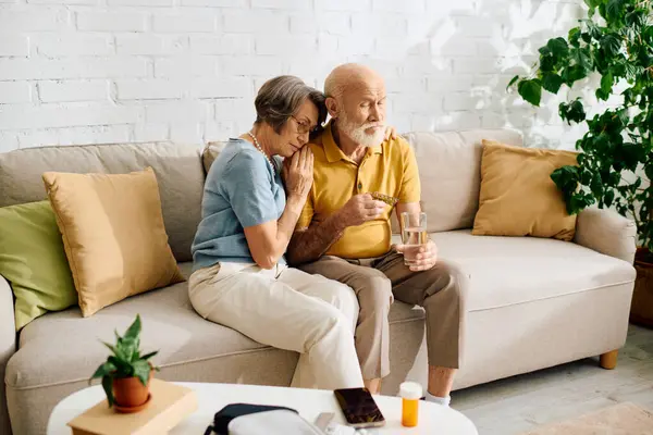 A loving couple shares a tender moment at home, focusing on health and companionship. — Stock Photo