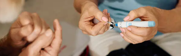 A compassionate wife assists her husband as he manages his diabetes at their cozy home. — Stock Photo