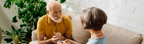 A senior couple shares a loving moment as the wife assists her husband with diabetes management. — Stock Photo