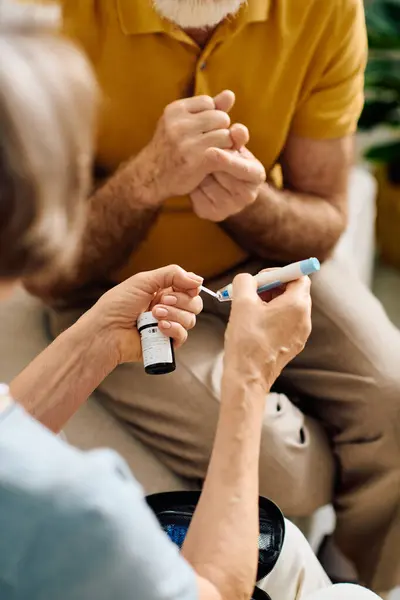 A devoted wife helps her husband manage diabetes while they enjoy their time together at home. — Stock Photo