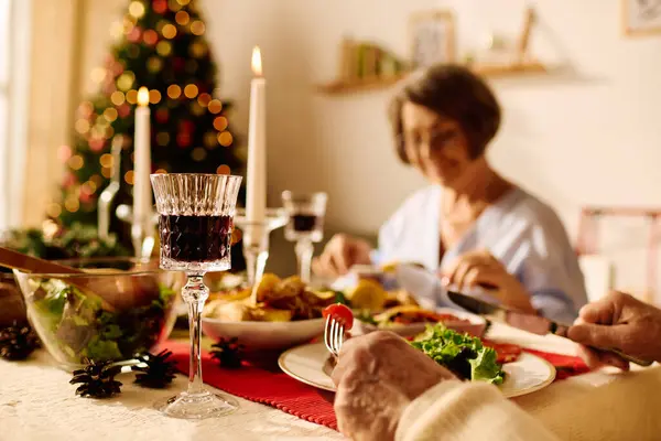 A warm Christmas dinner unfolds as a senior couple shares laughter and food at home. — Stock Photo