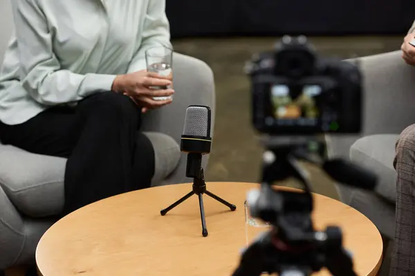 A middle-aged female journalist engages in a thoughtful interview with a man in a relaxed atmosphere. — Stock Photo
