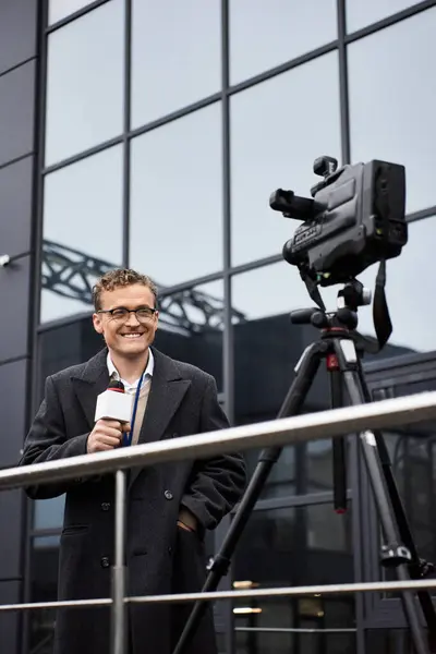 A dedicated journalist wearing glasses discusses current events outdoors, showcasing professionalism and charisma. — Stock Photo