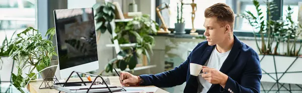 A focused man engages in work tasks in a stylish, plant-filled office space. — Stock Photo