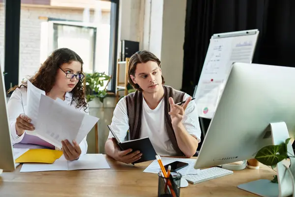 Eine junge Plus-Size-Frau und ihr männlicher Freund führen eine lebhafte Diskussion, während sie zusammen arbeiten. — Stockfoto