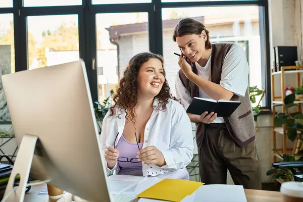 A young plus size woman smiles at her male friend in office. — Stock Photo