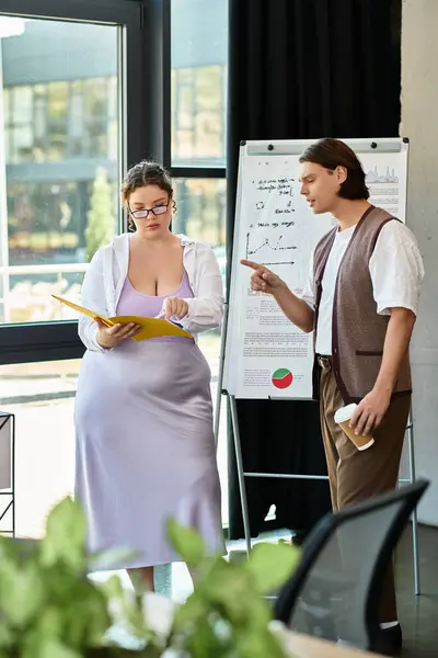 A young plus size woman reviews documents while her male friend gestures with an engaged expression. — Stock Photo