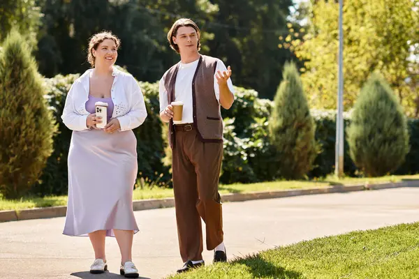 Two friends, a young plus size woman and her male companion, share laughter while walking. — Stock Photo