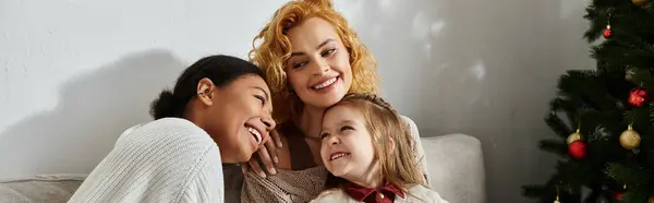 A beautiful family shares laughter and joy together in their cozy living room during the holidays. — Stock Photo