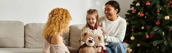 A loving couple shares smiles and laughter with their daughter while relaxing at home. — Stock Photo