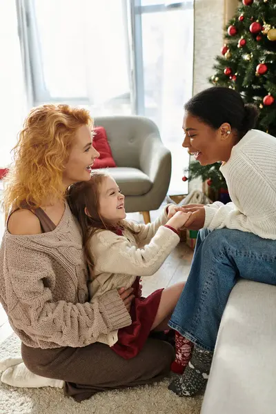 The affectionate family joyfully shares a moment together in their warm, festive home. — Stock Photo