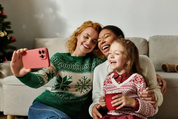 A vibrant celebration of love as a couple shares laughter with their daughter in a cozy setting. — Stock Photo
