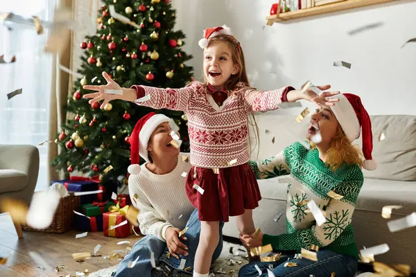 A delightful family enjoys a festive moment at home, celebrating together with laughter and joy. — Stock Photo