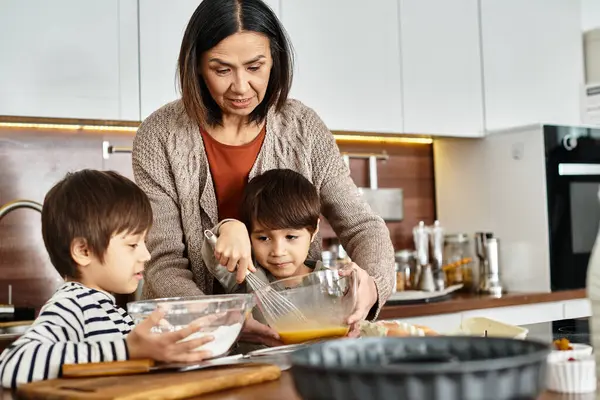 In a cozy kitchen, a cheerful grandmother enjoys baking festive treats with her grandsons before Christmas. — Stock Photo