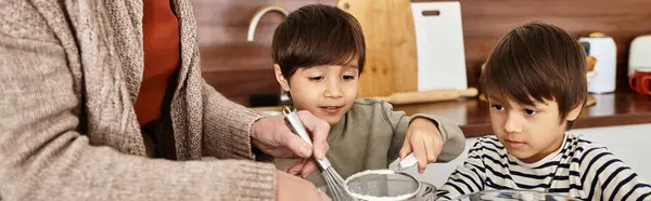 A happy grandmother teaches her grandsons to bake cookies for Christmas while enjoying the winter holidays. — Stock Photo