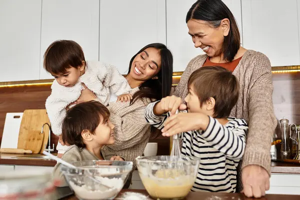 A happy family enjoys the warmth of cooking together, creating festive treats for Christmas with children engaged. — Stock Photo