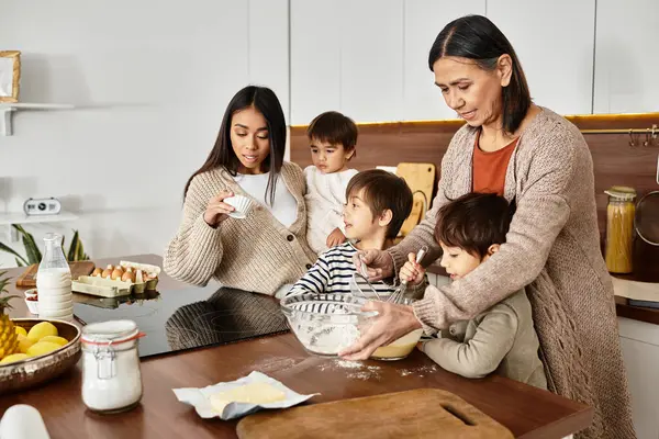 A happy family bonds while baking delicious treats in their modern kitchen just before Christmas. — Stock Photo