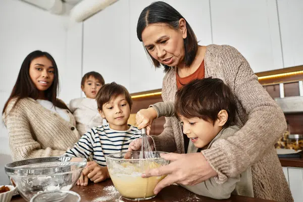 A cheerful family gathers in their stylish kitchen, baking festive treats and enjoying precious holiday moments. — Stock Photo