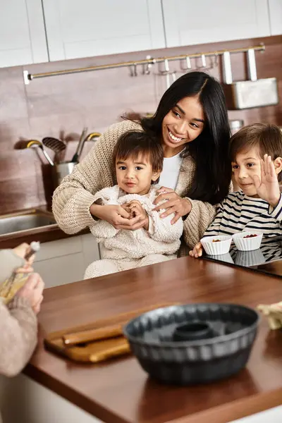 A happy family enjoys baking together in their contemporary kitchen, creating festive memories before Christmas. — Stock Photo