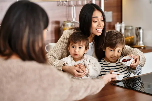 A joyful Asian family enjoys baking sweets together in their modern kitchen before Christmas. — Stock Photo