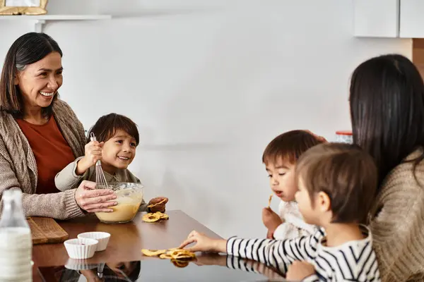 A joyful family cooks festive treats in their modern kitchen, enjoying precious moments together. — Stock Photo