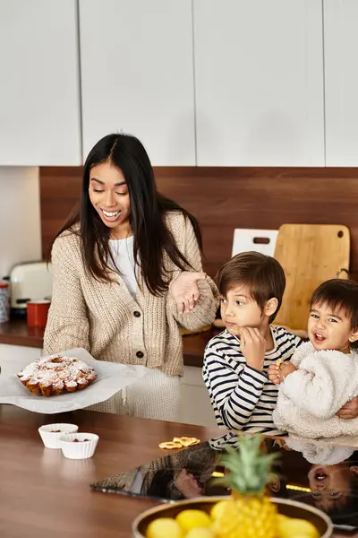 A happy family with children enjoys baking festive treats in their modern kitchen before Christmas. — Stock Photo