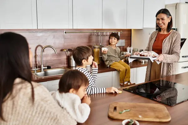 A cheerful family enjoys baking together in a contemporary kitchen, creating memories around Christmas. — Stock Photo